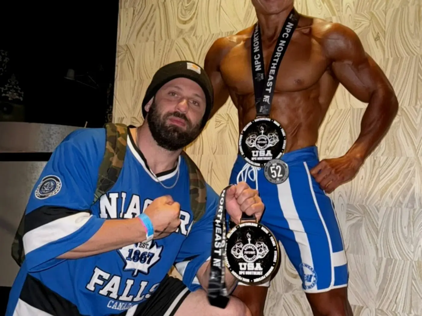 Coach with athlete holding NPC Northeast medals